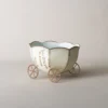 Pot de fleur intérieur blanc avec finition vieillie, associé à des fleurs violettes et décor de table champêtre.