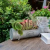 Pot de fleurs moderne en forme de tuyau cylindrique, idéal pour un style minimaliste et urbain.